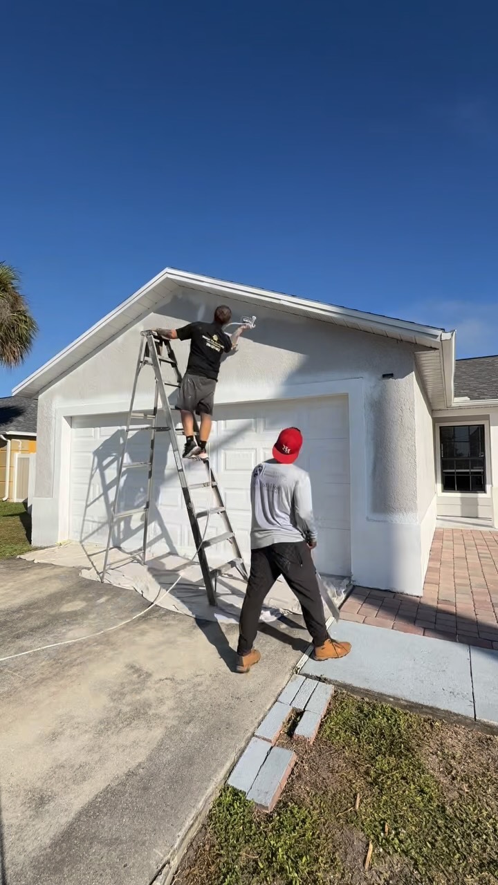Millan's Pro Services team painting exterior of home